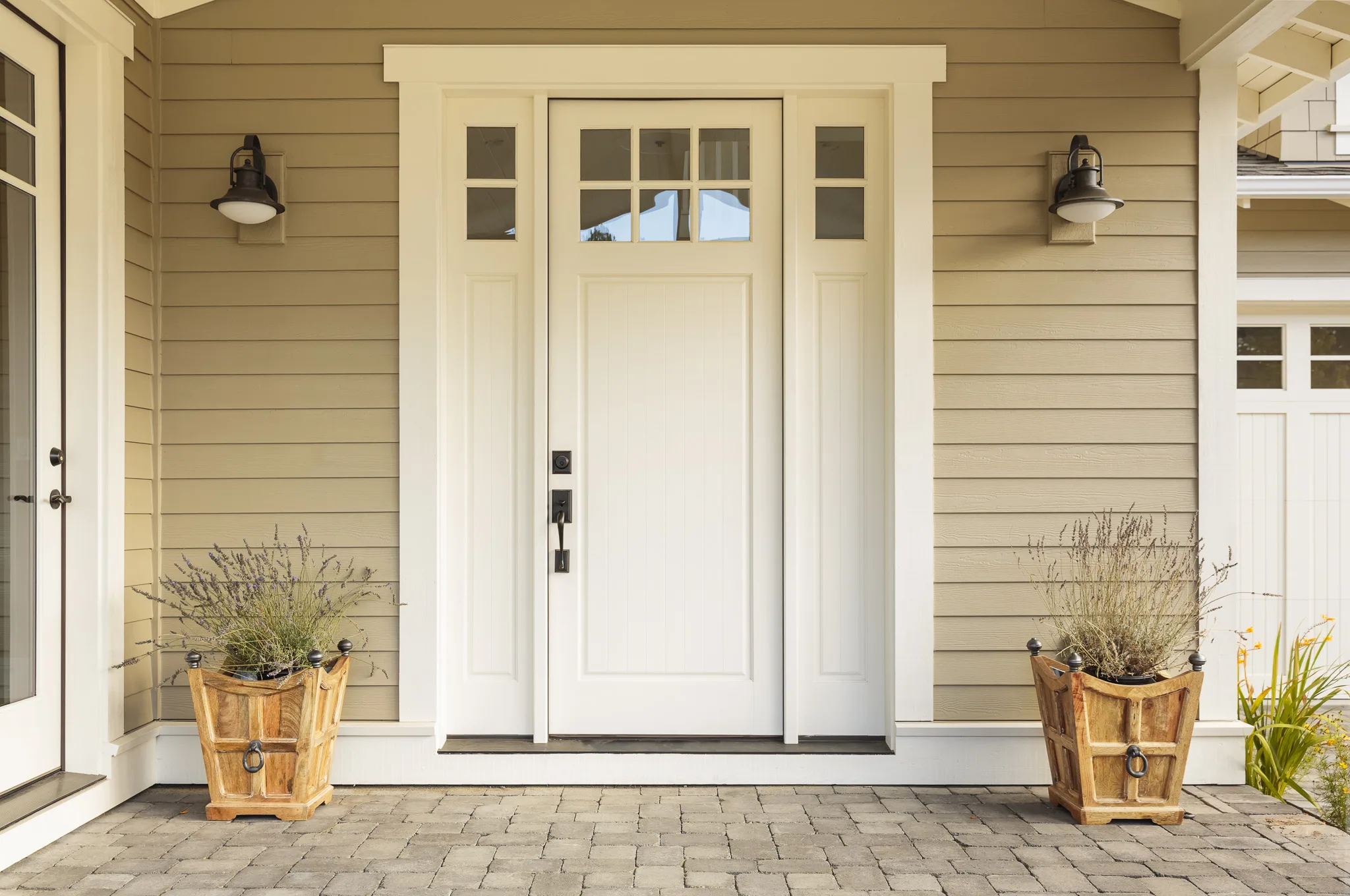 White front door with potted plants